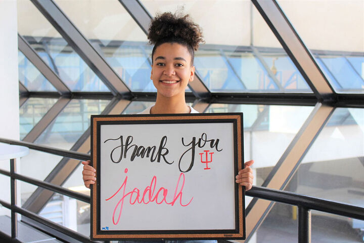 Student holding thank you sign